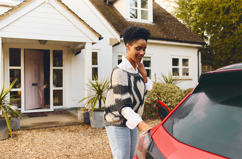 Woman-Charging-Red-Car-at-Home-1000x1000-1.png