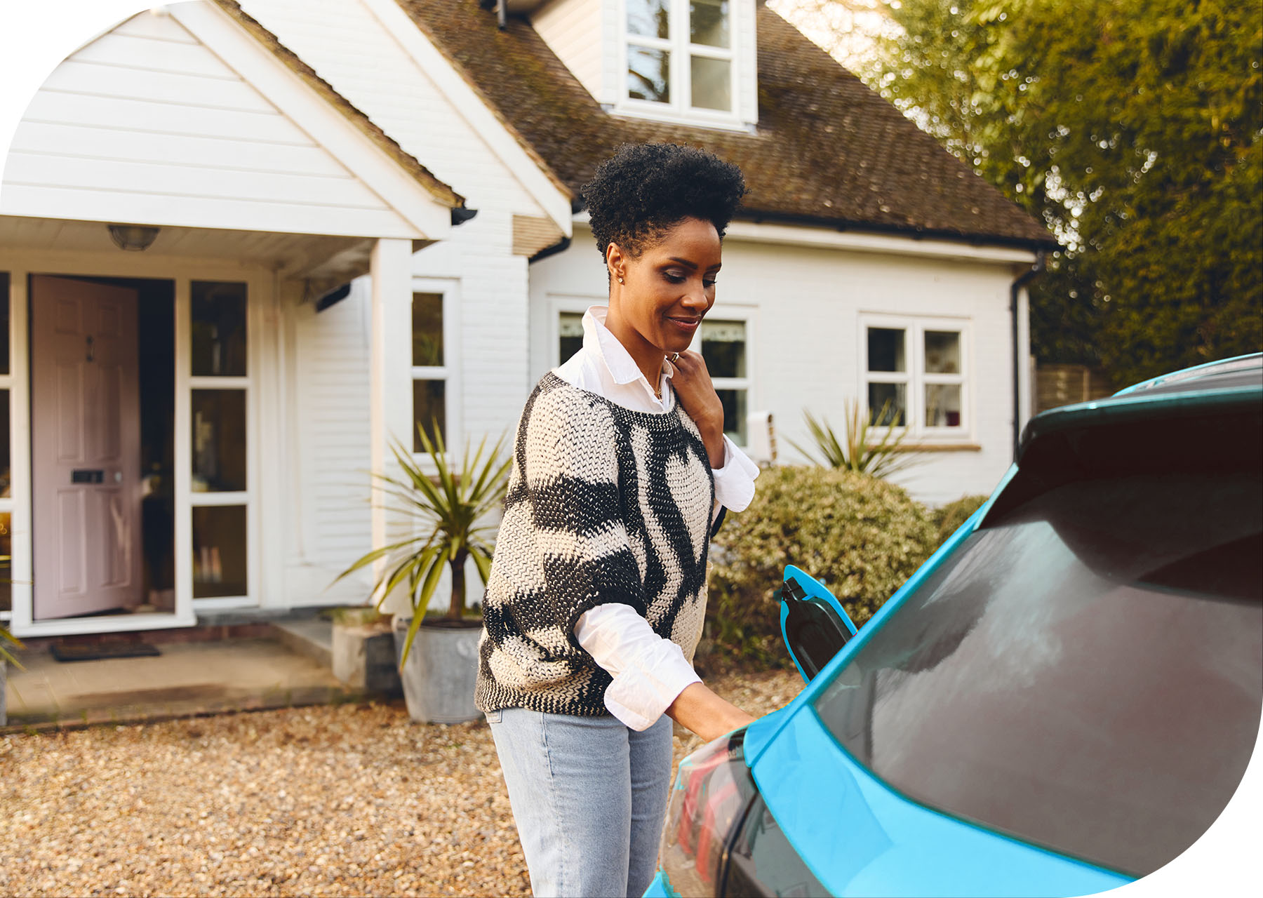 Rounded-Rectangle-Woman-charging-blue-car-at-home.jpg