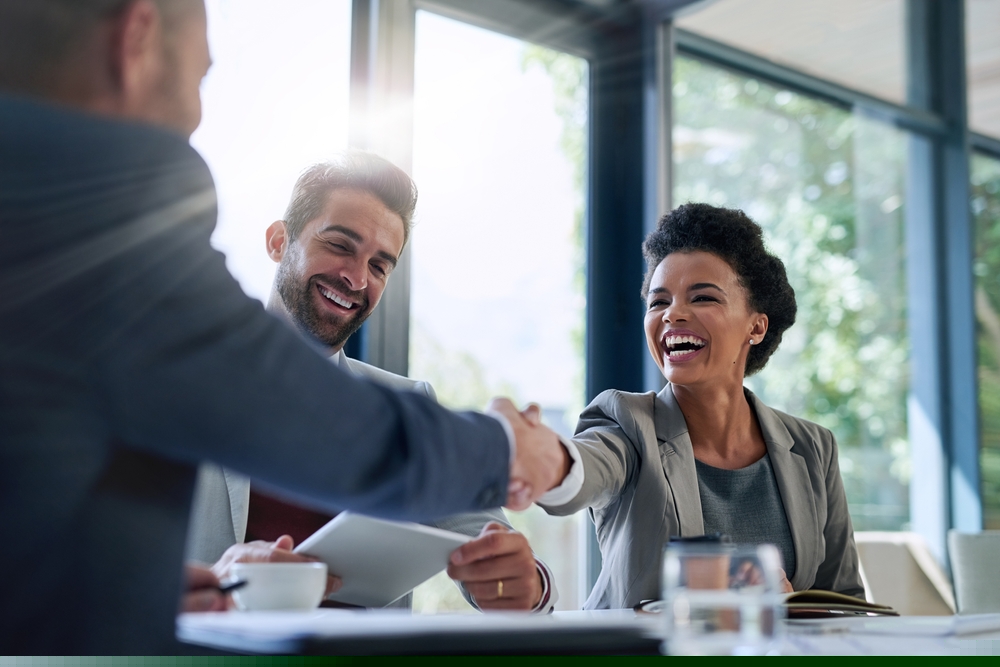 Two employees shaking hands
