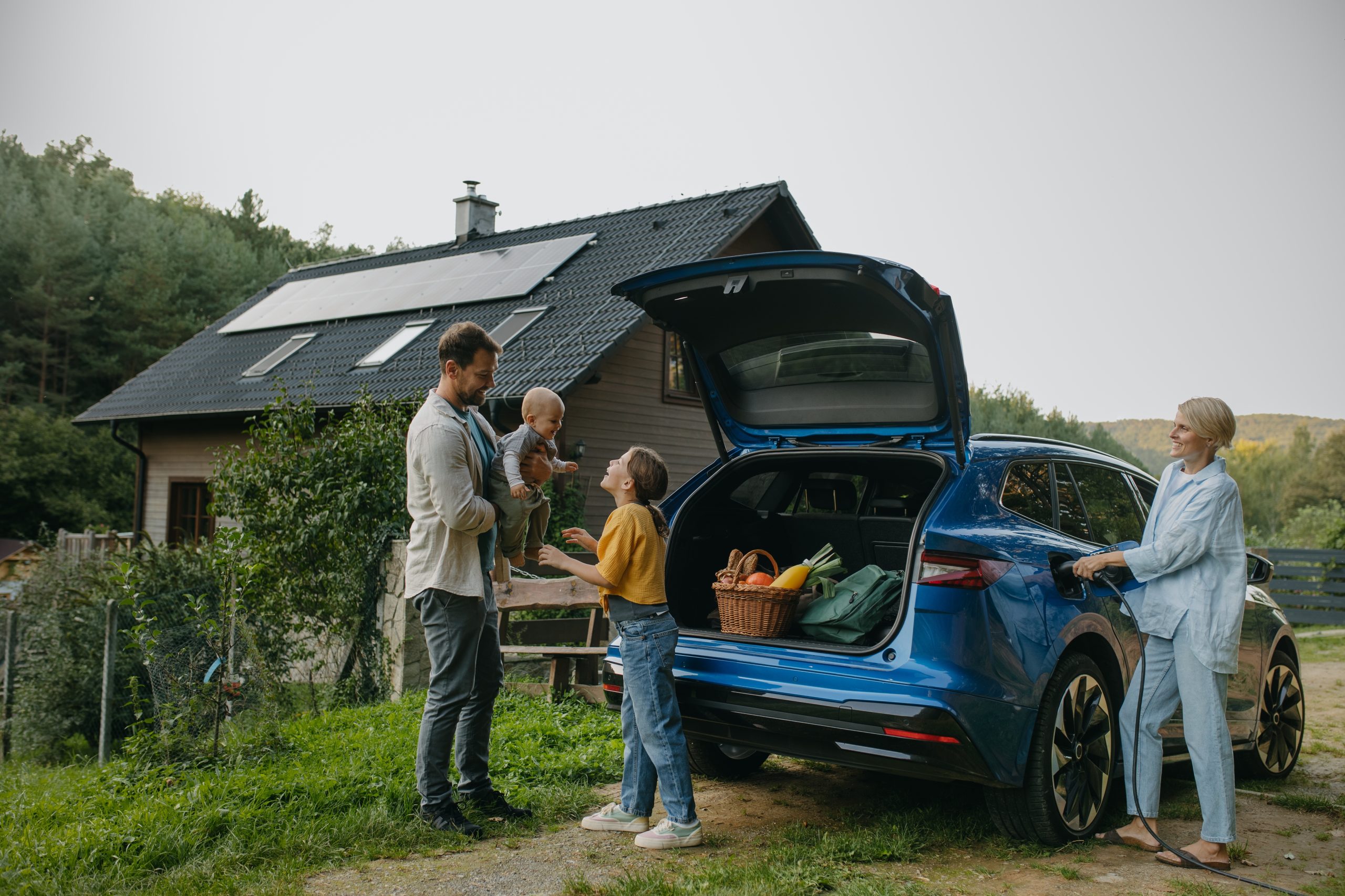 family-with-charging-EV-scaled.jpg